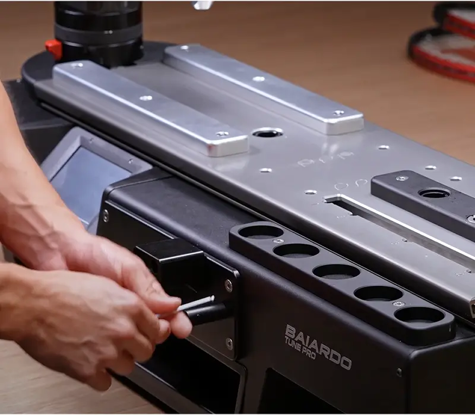 Person setting up Baiardo Stringing machine