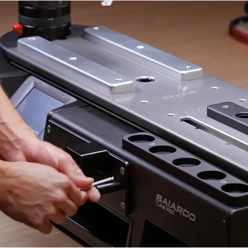 Person setting up Baiardo Stringing machine