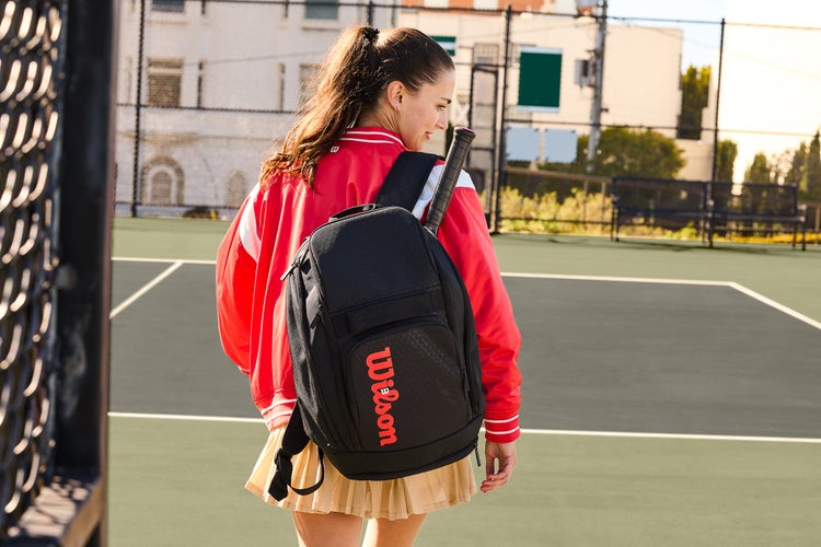 Tennis player wearing backpack