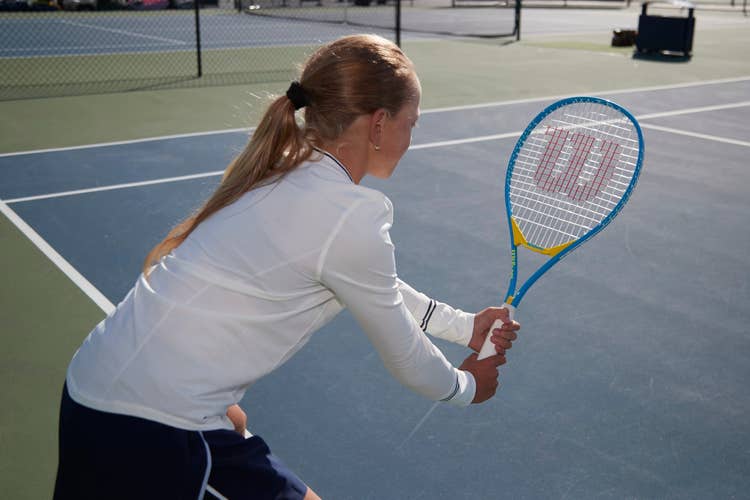 Kid playing with a Wilson junior racket