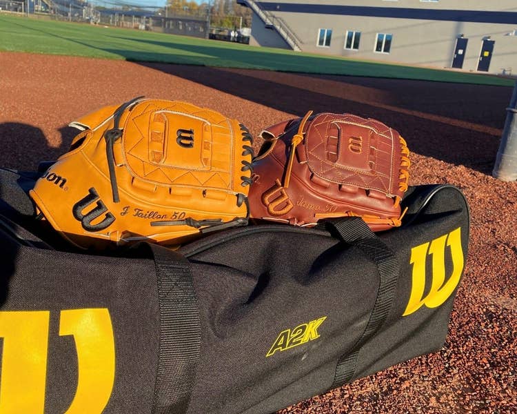 wilson game model ball gloves on a duffle bag