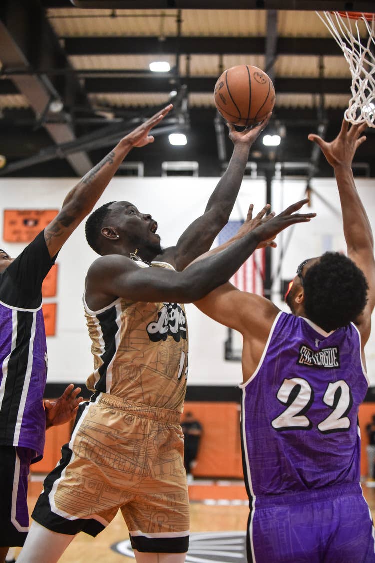 players leaping for a basketball