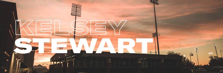 Sunset over a stadium with the words
