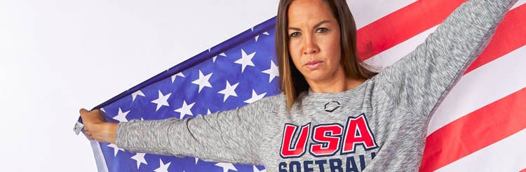 Photo of Cat Osterman with a flag behind her
