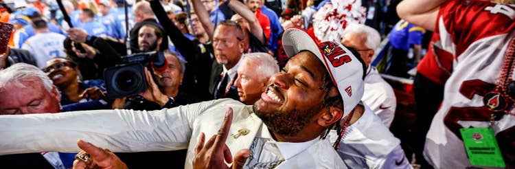 Paris Johnson Jr. celebrating in a crowd after being drafted 6th overall