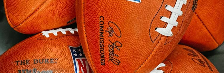 close up of pile of footballs