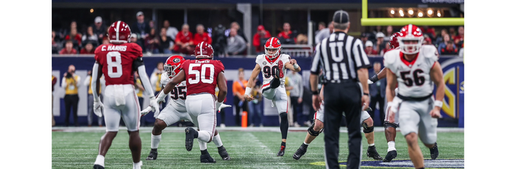jake camarda punting a football in a game