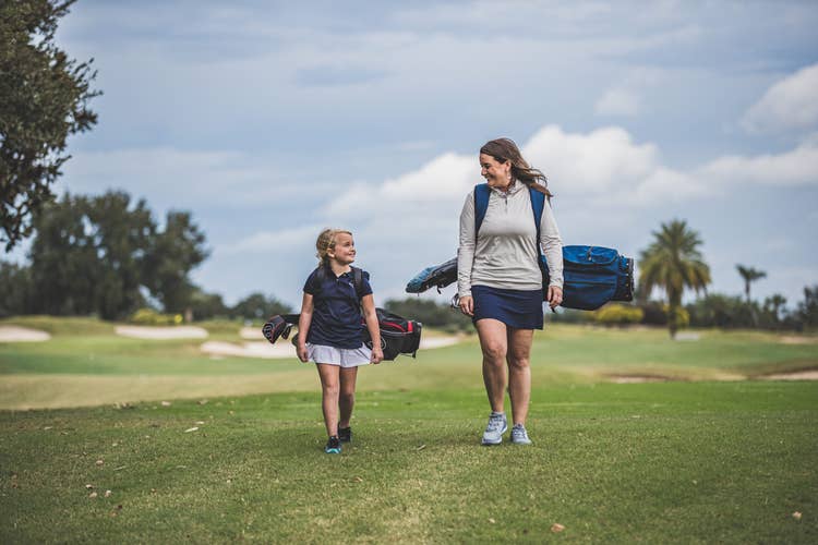 a mother and daughter on the fairway