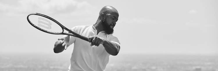 black and white photo of Wkwesi Williams hitting a backhand