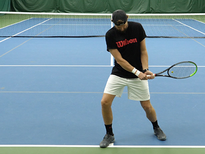 closer photo of a backhand stance on court.