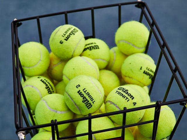 a hopper of tennis balls