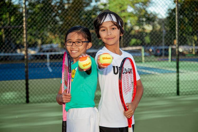 young girl and boy tennis students