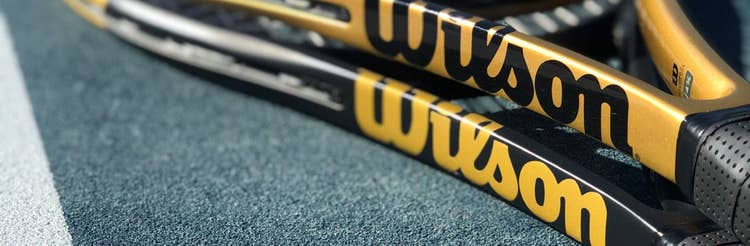 closeup of black and gold custom tennis rackets