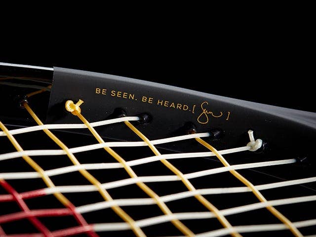Close up of SW102 Autographed Tennis Racket that reads "be seen, be heard"