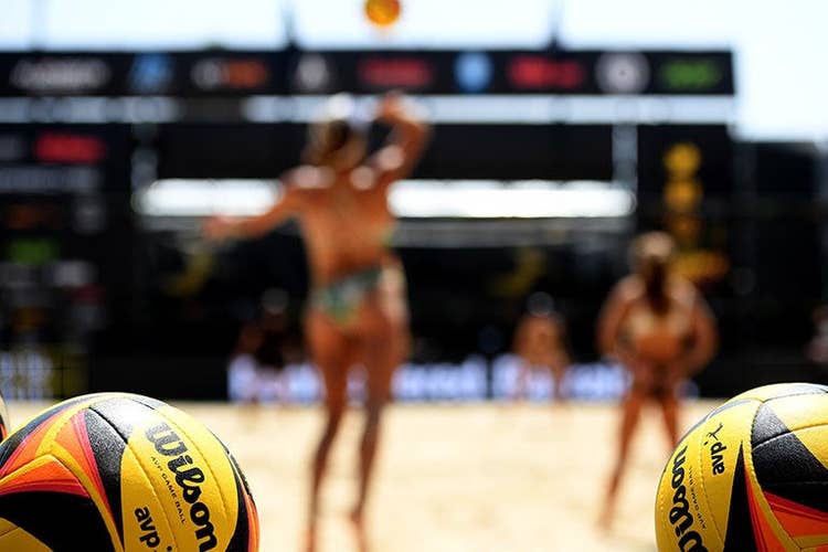 two Optx balls with players in the background