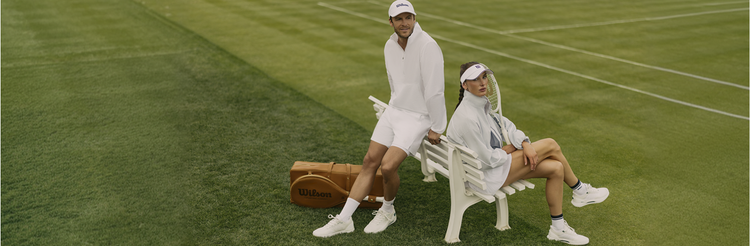 man and woman dressed in Wilson tennis whites on a grass court