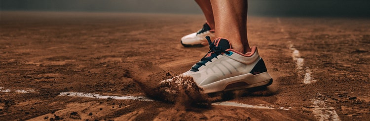 Tennis player sliding on clay court