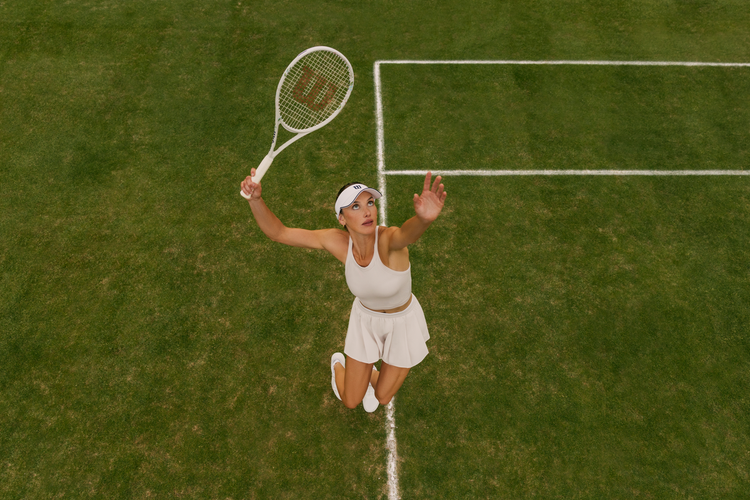 woman dressed in Wilson tennis whites on a grass court