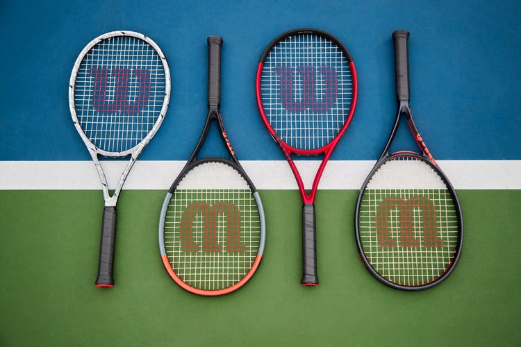 Four Clash tennis racquets lying on a court