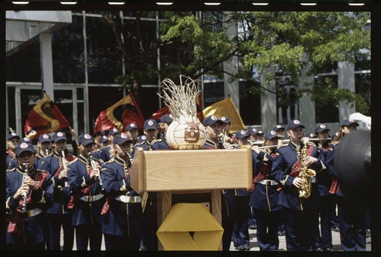 Wilson the Volleyball at a podium in front of a crowd