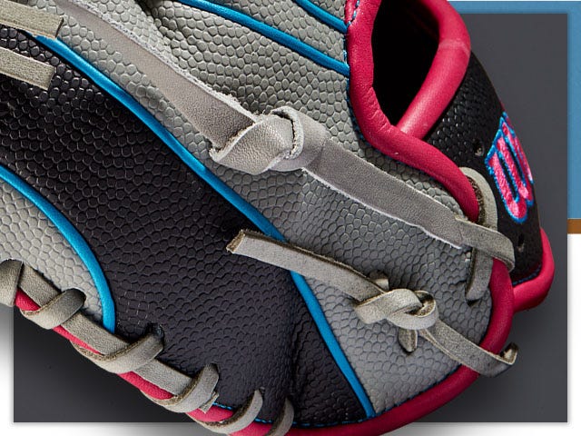 close up of gray blue and red baseball glove showing stitching