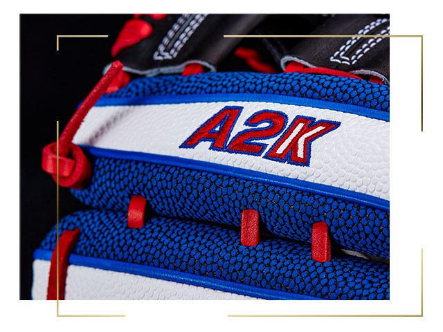 close up of bright blue and white baseball glove, with red A2K logo