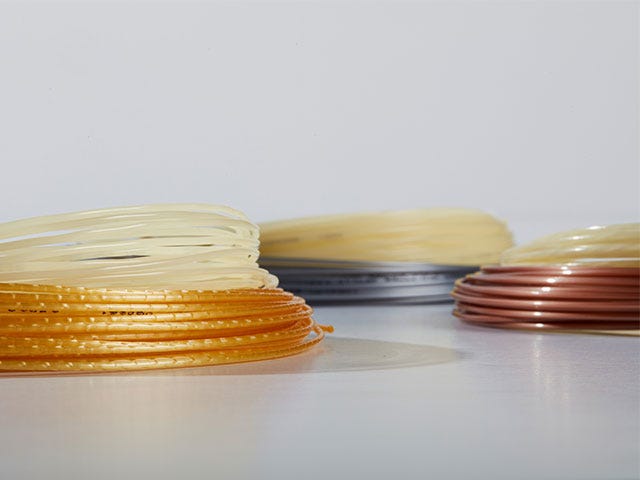 Different reels of tennis strings